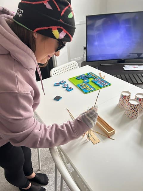 A trainee taking part in a hands-on word-building activity during a Cuckmere Training session