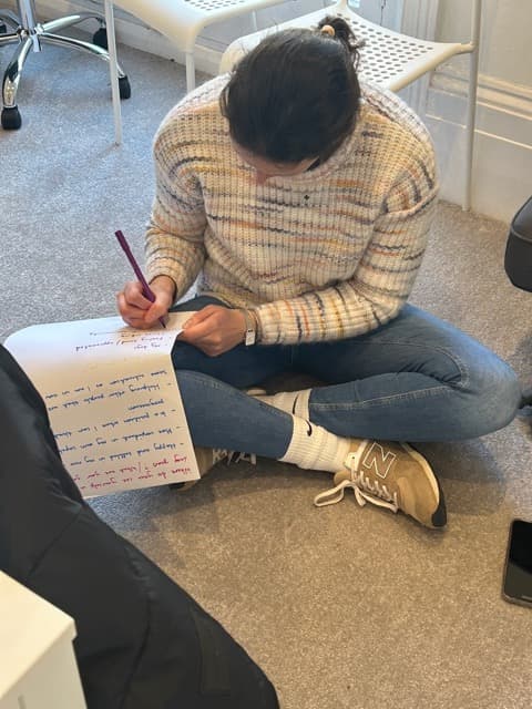 A Cuckmere Training learner writing reflective notes during a session